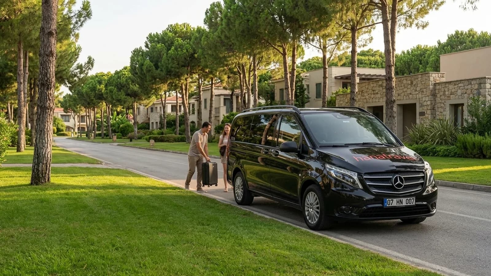 Из аэропорта Анталии в отель Белека: как устроен путь от трапа до номера A sleek black transfer van stands parked on a quiet, pine-lined resort road in Belek.